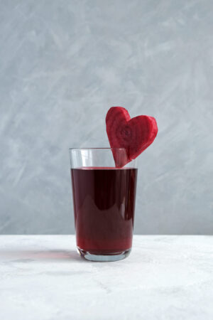 Healthy drink with beetroot juice. Glass of red beverage decorated slice of beet heart shaped. Salgam. Fermented homemade drinks Organic Kanji Drink by Dream4Health